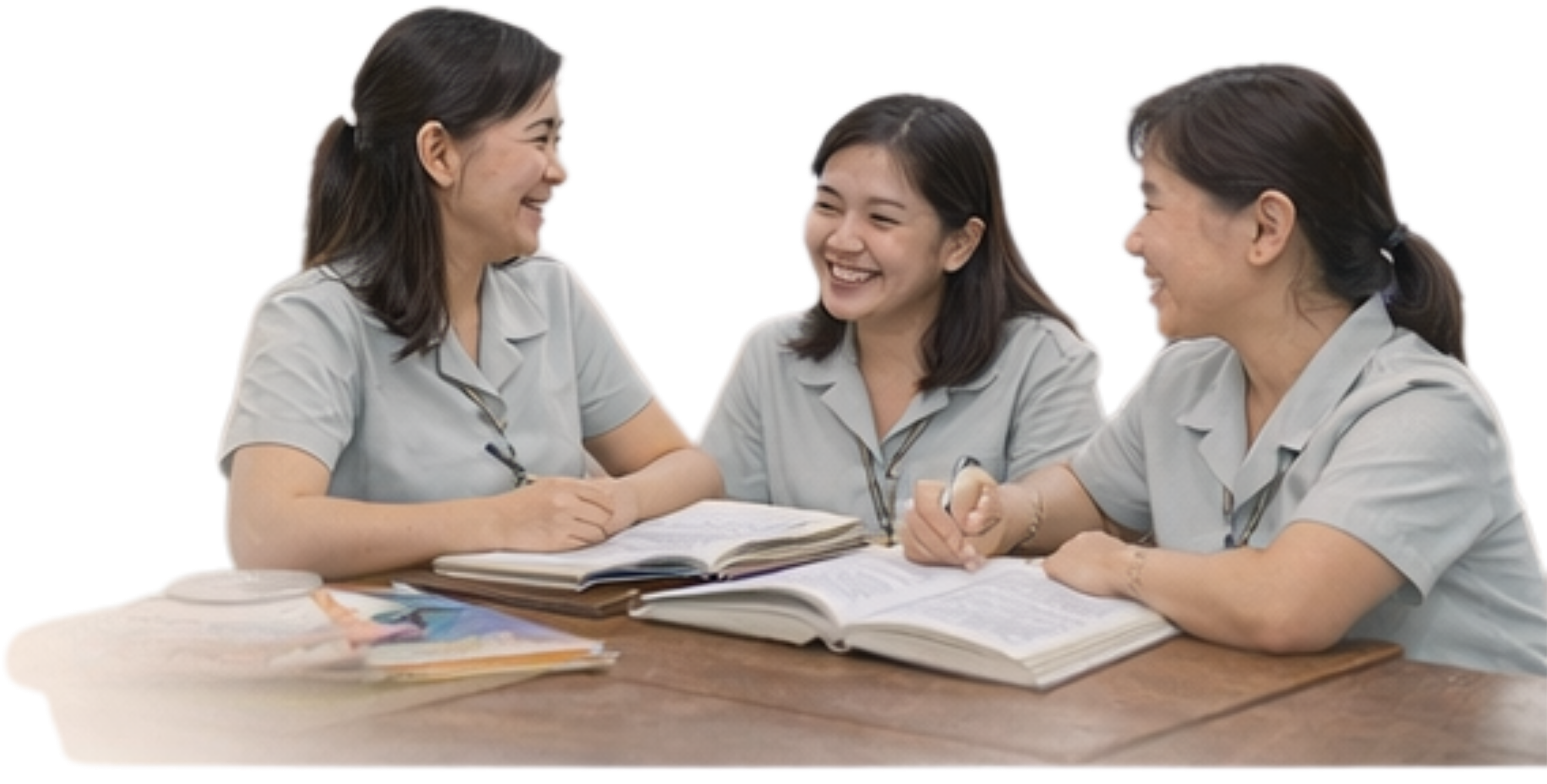 Three teachers sitting together and smiling